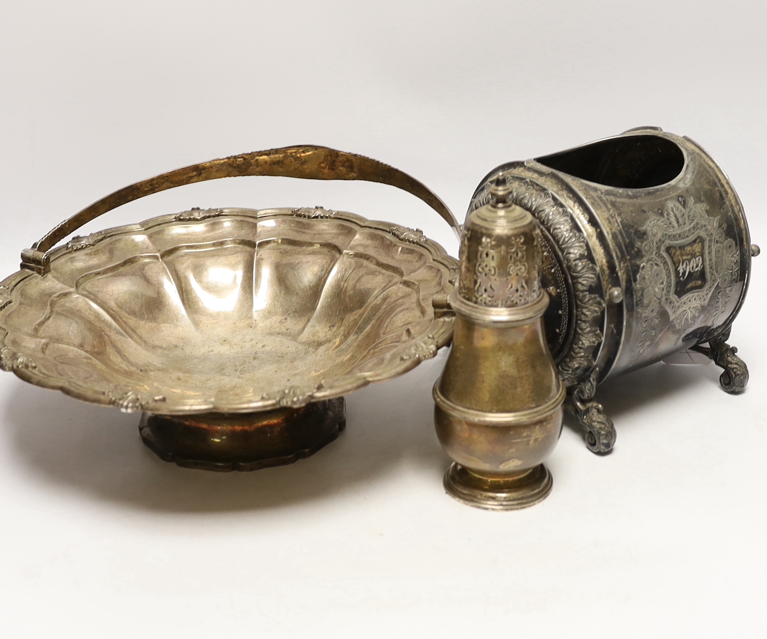 A George IV silver bread basket, London, 1827? (marks rubbed), diameter 31cm, together with a 1930's silver sugar caster, gross 40.2oz and a Brittania metal biscuit barrel.